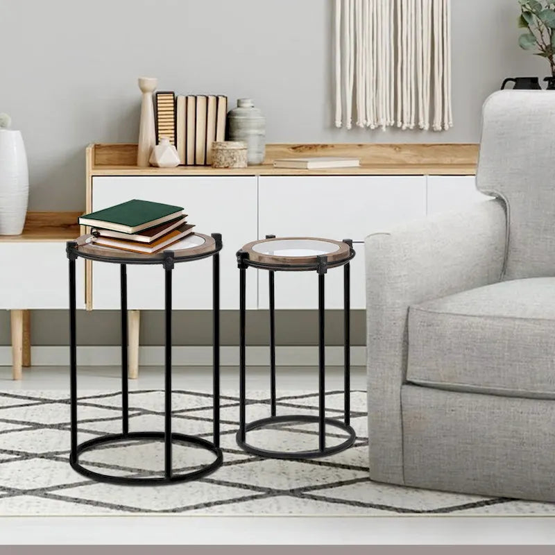 Set di 2 tavolini d'appoggio moderni rotondi, struttura in metallo nero, ripiano in vetro trasparente, cornice in legno di abete, salvaspazio